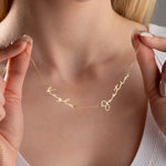 Personalized 3 name necklace for women showing hand adjusting gold chain
