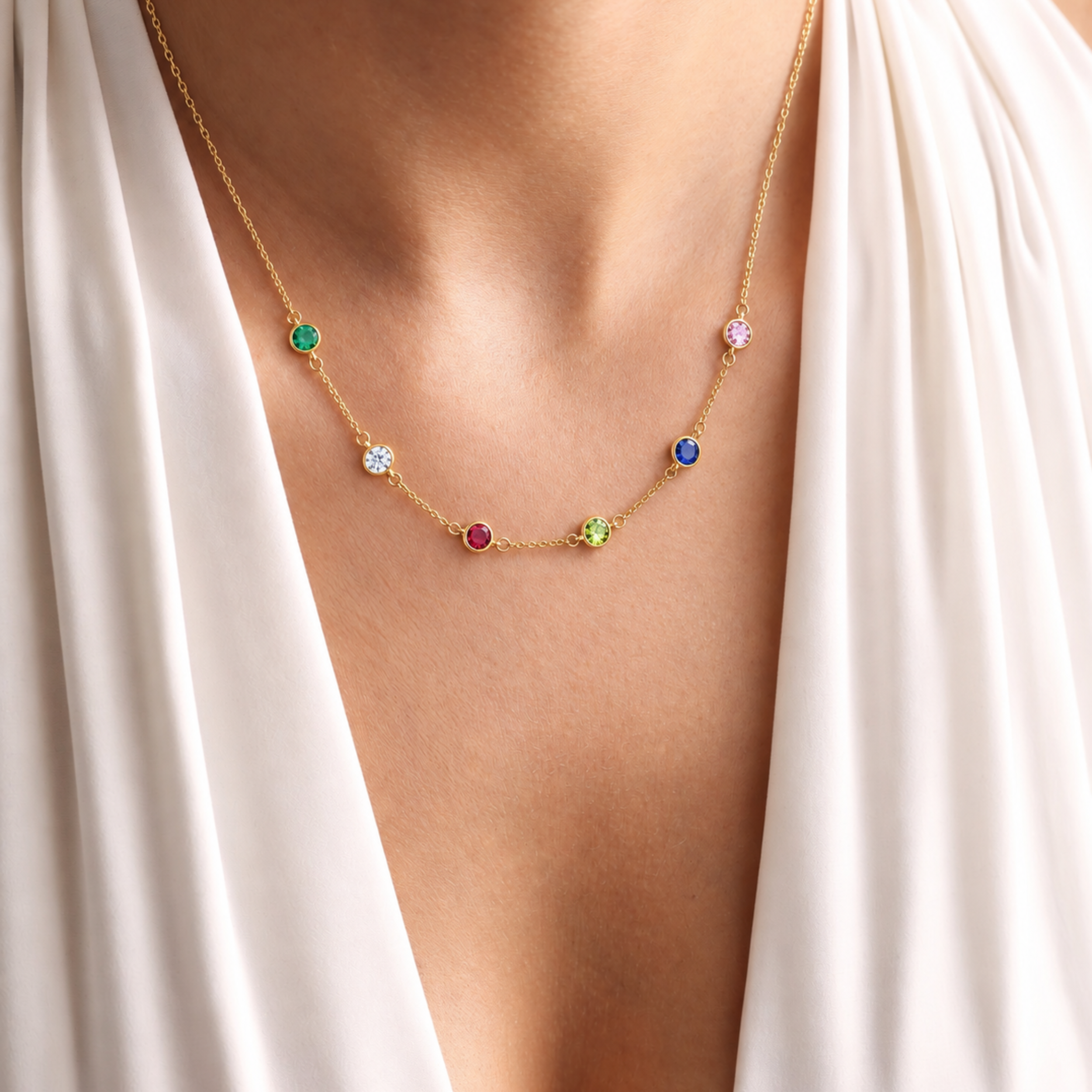 Family birthstone necklace worn on neck — station style with colourful gemstones in sterling silver