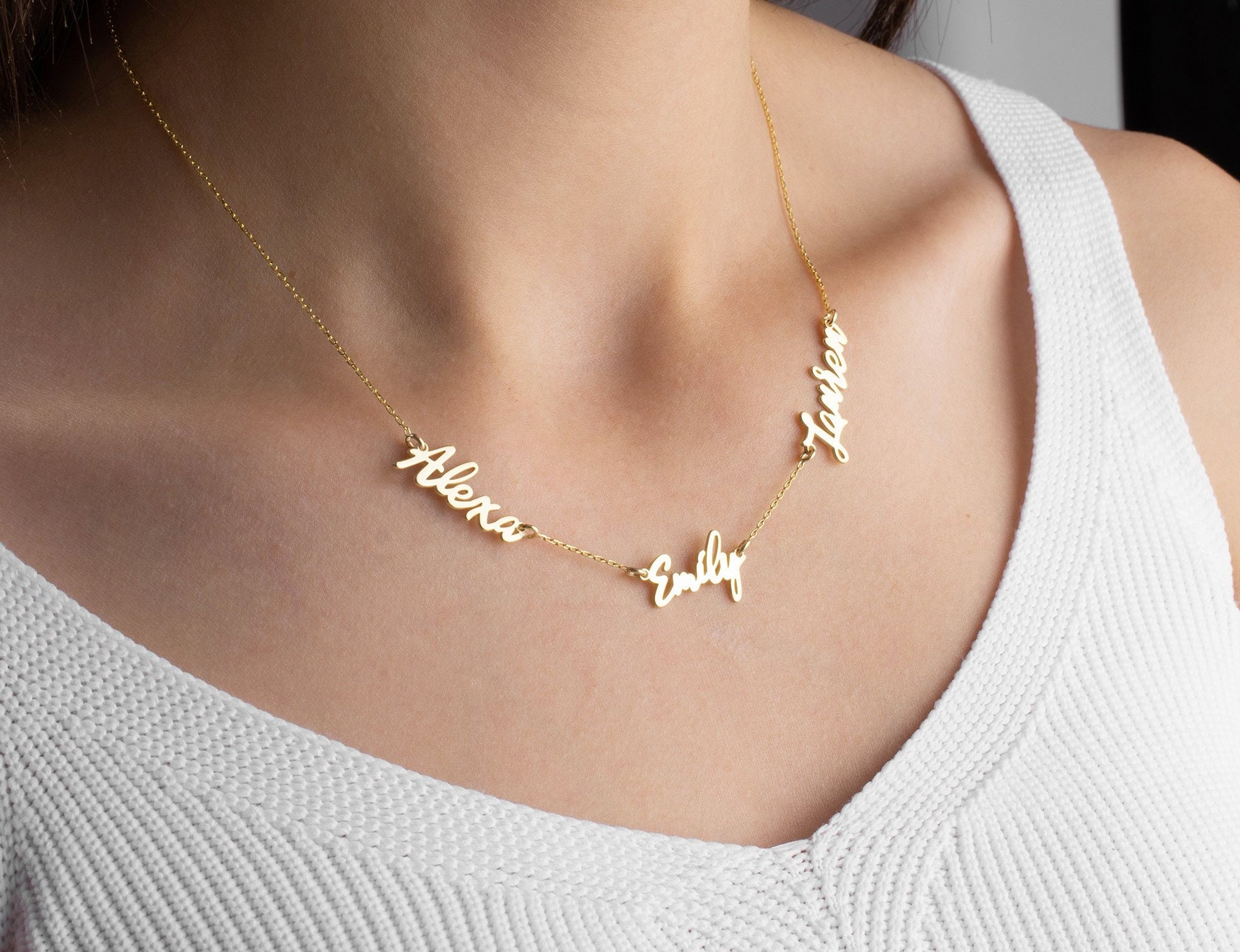 Custom 3 name necklace in gold plated 925k sterling silver worn by woman
