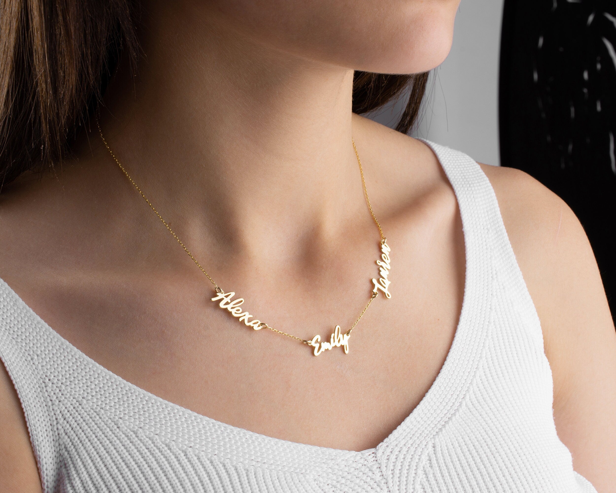 Close up of 925 sterling silver personalized 3 name necklace in gold plating
